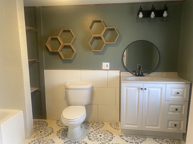 full bath with toilet, tile patterned floors, a washtub, vanity, and tile walls