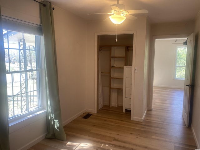 interior space with light wood finished floors, baseboards, and visible vents