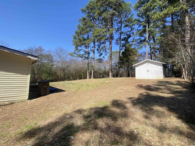 view of yard with an outbuilding and a storage shed