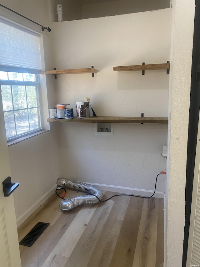 washroom featuring washer hookup, wood finished floors, visible vents, and baseboards