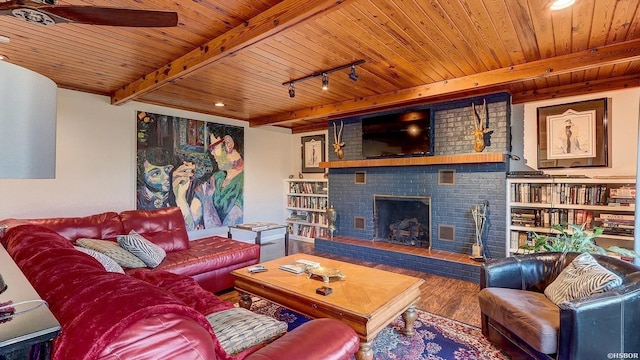 living area featuring a brick fireplace, wooden ceiling, beam ceiling, and wood finished floors