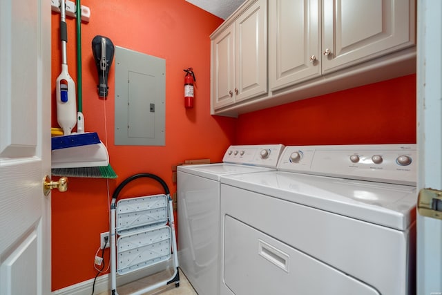 clothes washing area featuring electric panel, cabinet space, and washing machine and clothes dryer