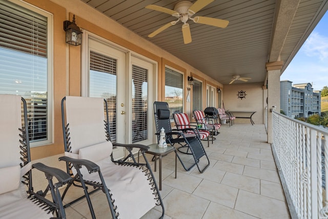 view of patio / terrace with a balcony and ceiling fan