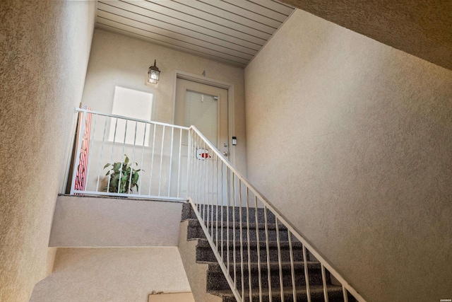 stairway with a textured wall