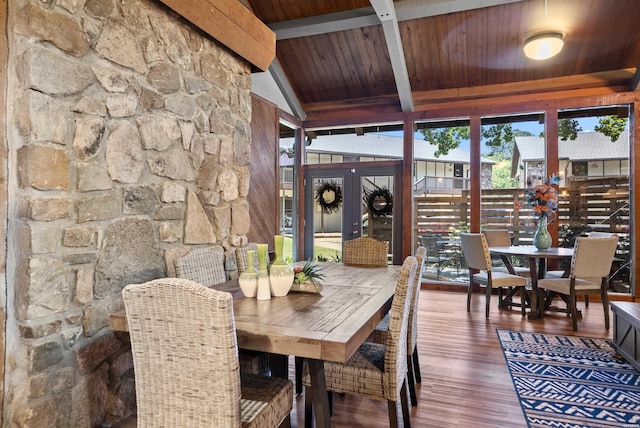 sunroom / solarium featuring lofted ceiling with beams and wood ceiling