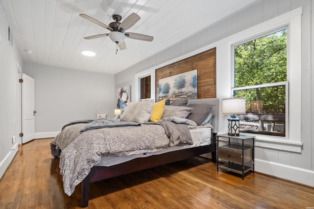 bedroom featuring ceiling fan, wood finished floors, wood ceiling, and baseboards