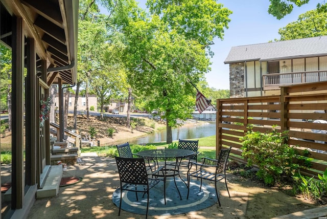 view of patio with outdoor dining space and a water view