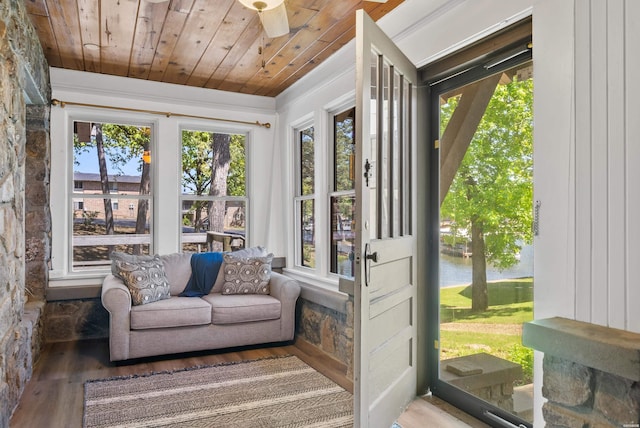 sunroom featuring plenty of natural light, a water view, and wooden ceiling