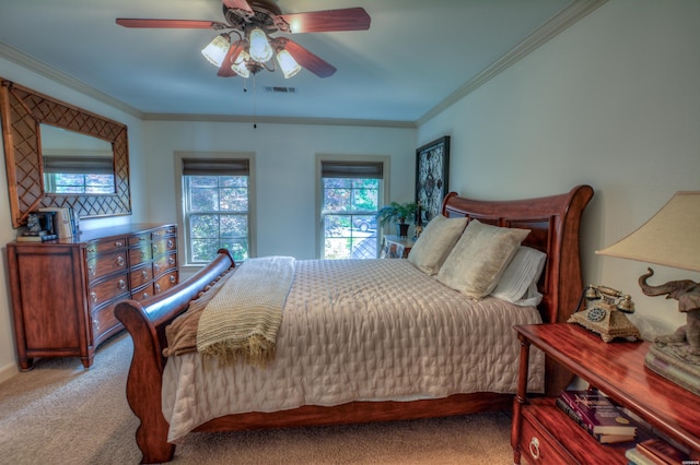 bedroom featuring a ceiling fan, visible vents, crown molding, and light carpet