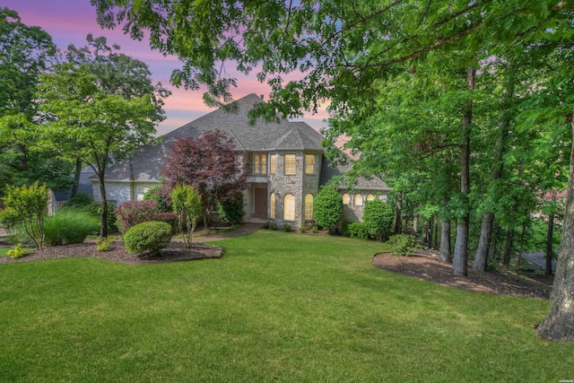 view of front of home featuring stone siding and a front lawn