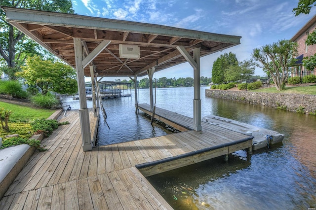 dock area with a water view and boat lift