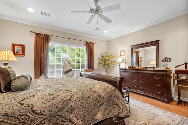 bedroom featuring ornamental molding, visible vents, and light wood-style flooring