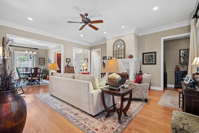 living room with crown molding, light wood-type flooring, and a fireplace