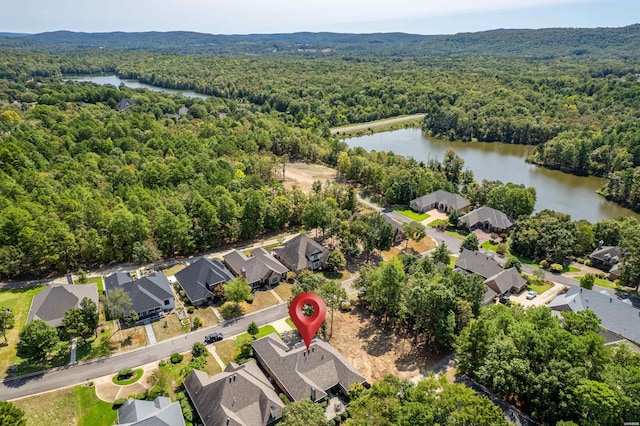 bird's eye view with a water view, a wooded view, and a residential view