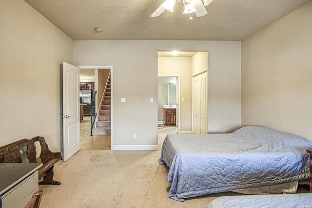 451 Lakeland Dr Unit G-4, Hot Springs, AR 71913 - bedroom featuring light carpet, baseboards, a ceiling fan, ensuite bath, and a textured ceiling