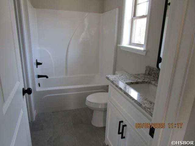 bathroom featuring toilet, tile patterned flooring,  shower combination, and vanity