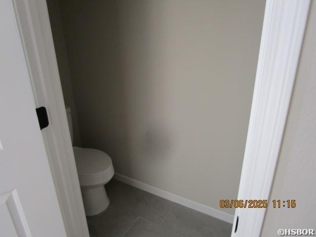 bathroom featuring tile patterned floors, toilet, and baseboards