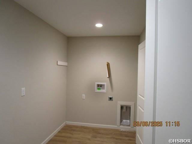 washroom featuring hookup for a washing machine, laundry area, light wood-style flooring, and baseboards