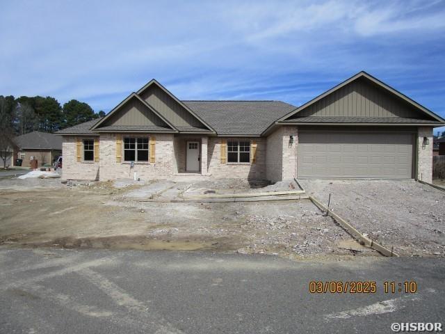 view of front of property with brick siding and an attached garage