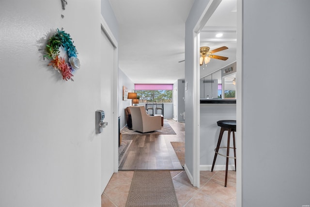 hall featuring light tile patterned floors