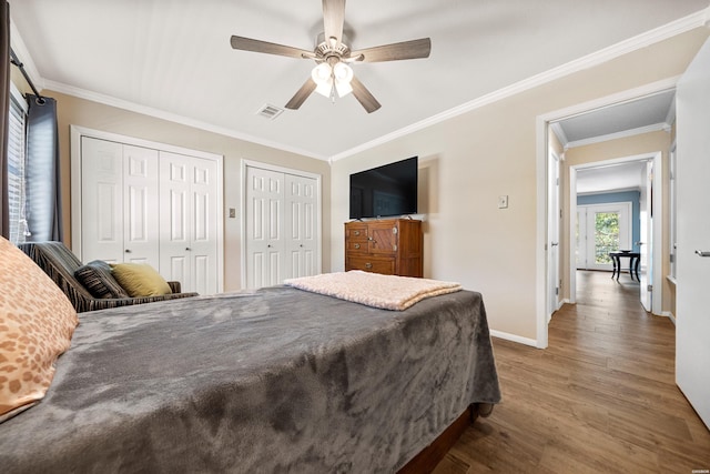 1201 Airport Rd Unit D-14, Hot Springs, AR 71913 - bedroom with multiple closets, wood finished floors, baseboards, ornamental molding, and a ceiling fan