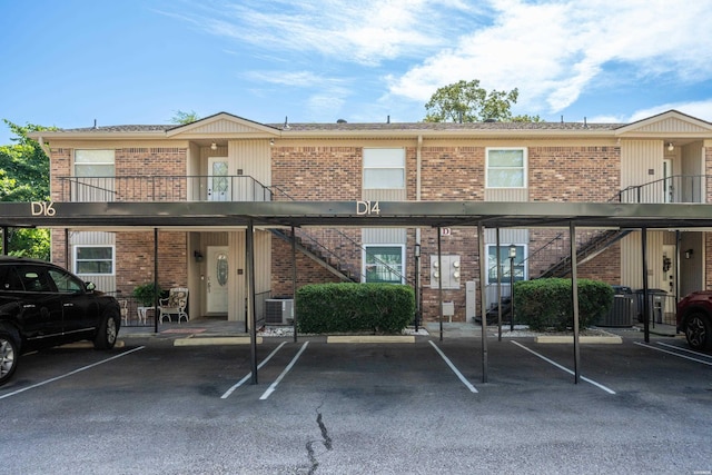 1201 Airport Rd Unit D-14, Hot Springs, AR 71913 - view of front facade with stairs, brick siding, covered parking, and cooling unit