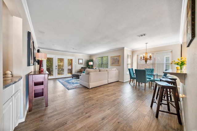 1201 Airport Rd Unit D-14, Hot Springs, AR 71913 - living room with crown molding, a chandelier, french doors, wood finished floors, and baseboards