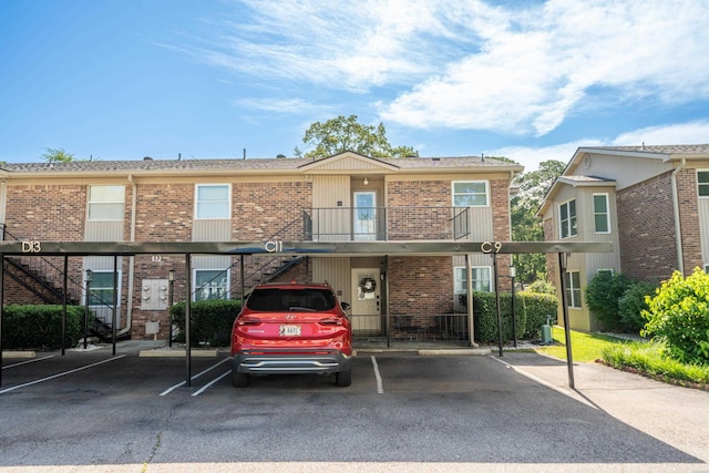 1201 Airport Rd Unit D-14, Hot Springs, AR 71913 - view of property featuring stairs, brick siding, and covered parking