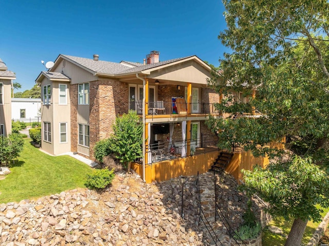 1201 Airport Rd Unit D-14, Hot Springs, AR 71913 - view of front of property with a chimney, a balcony, brick siding, a front yard, and stairway