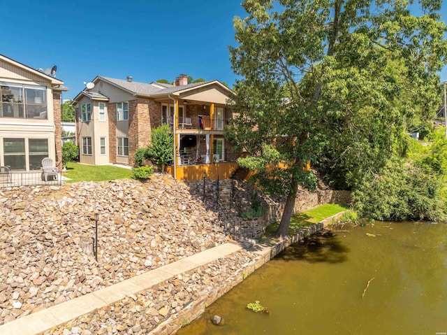 1201 Airport Rd Unit D-14, Hot Springs, AR 71913 - back of house featuring brick siding, a balcony, and a chimney