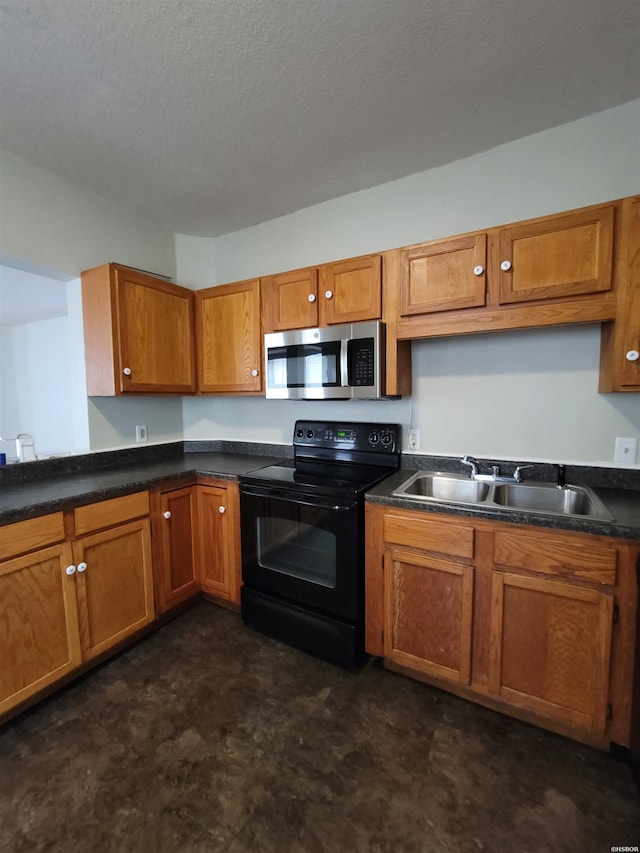 kitchen featuring black / electric stove, a sink, brown cabinetry, stainless steel microwave, and dark countertops