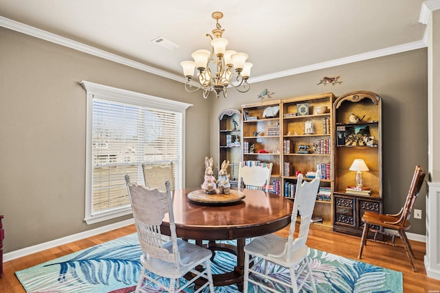 121 Wildwood Forest Rd, Hot Springs, AR 71913 - dining room featuring ornamental molding, light wood-style flooring, a notable chandelier, and visible vents