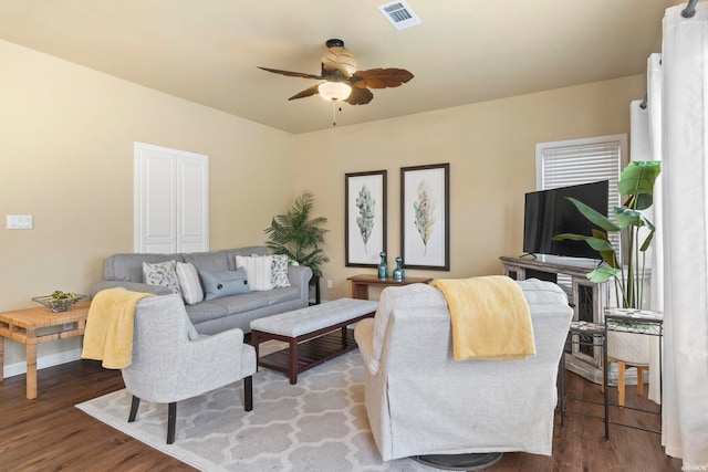 living area featuring wood finished floors, visible vents, and a ceiling fan