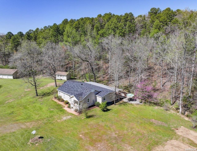 view of subject property with a heavily wooded area