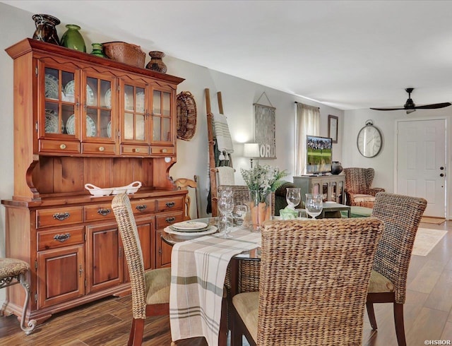 dining space with wood finished floors and a ceiling fan