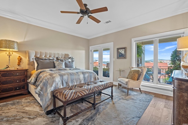 bedroom with visible vents, a ceiling fan, wood finished floors, access to exterior, and crown molding