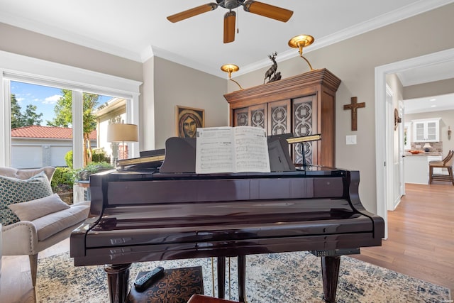 living area featuring ornamental molding and light wood finished floors