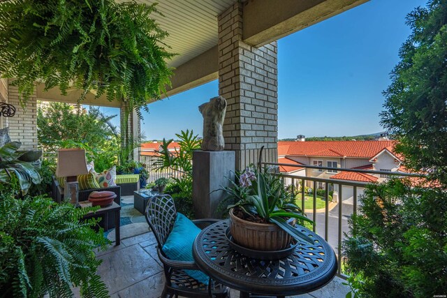 view of patio featuring a balcony