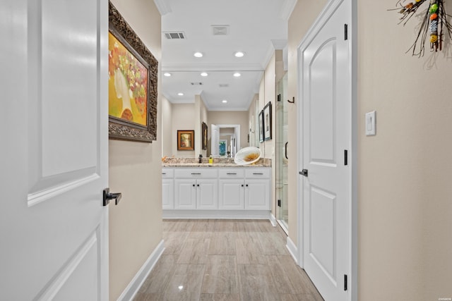 interior space with recessed lighting, visible vents, crown molding, and vanity