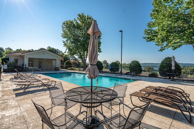 community pool featuring a patio and fence