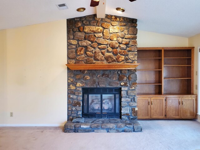 unfurnished living room featuring vaulted ceiling with beams, a fireplace, visible vents, light carpet, and baseboards