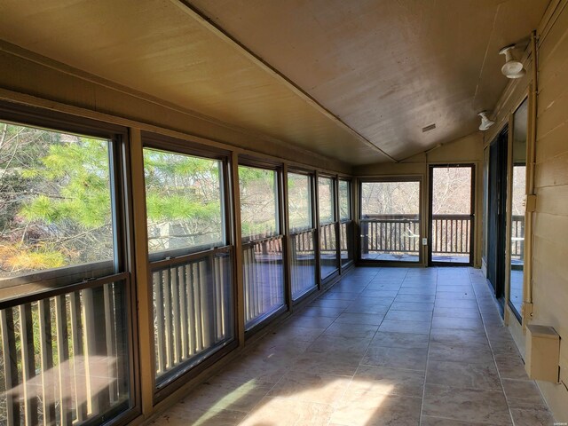 unfurnished sunroom with wood ceiling and vaulted ceiling