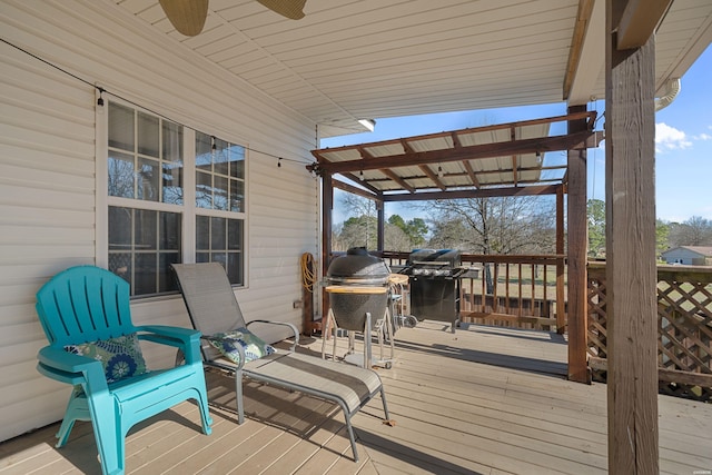 wooden terrace with a grill, a pergola, and a ceiling fan