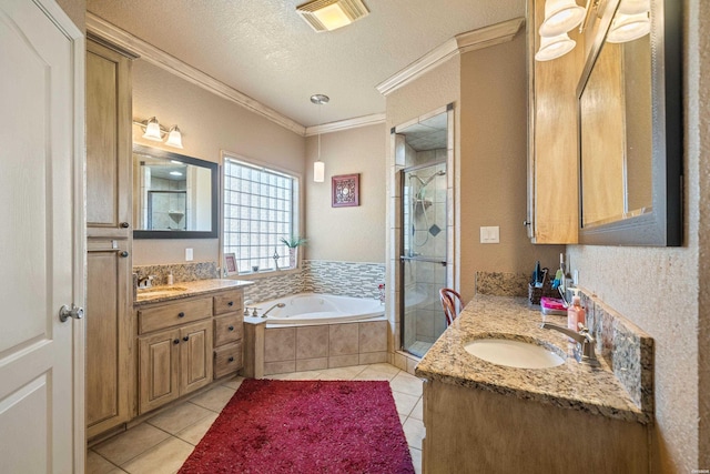 bathroom featuring ornamental molding, a stall shower, visible vents, and a sink