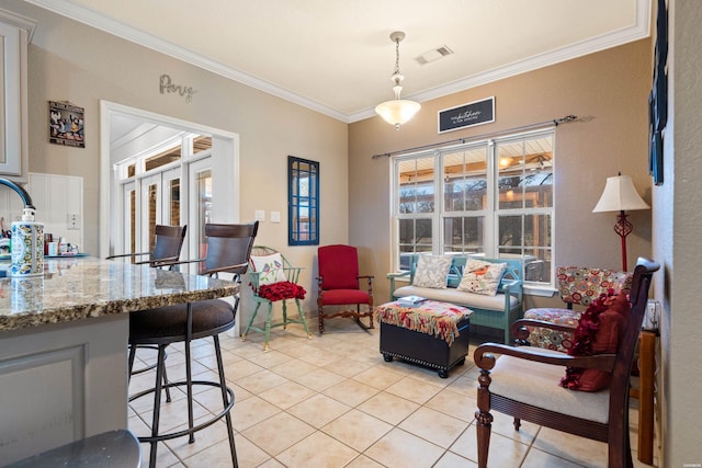 dining space featuring light tile patterned floors, visible vents, and crown molding