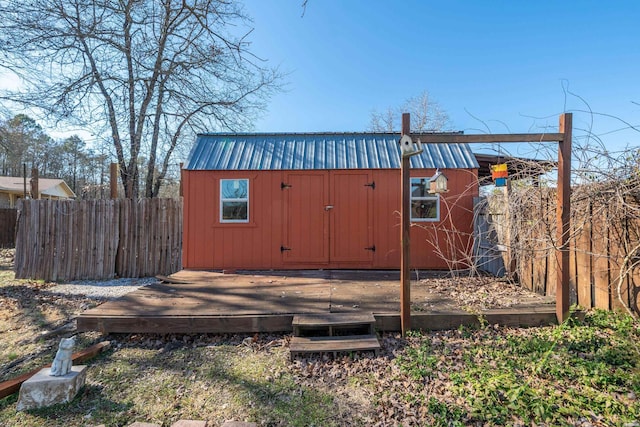 view of shed featuring fence