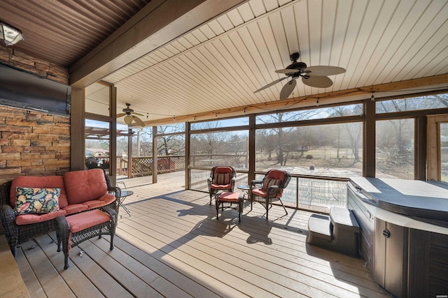 deck featuring glass enclosure and ceiling fan