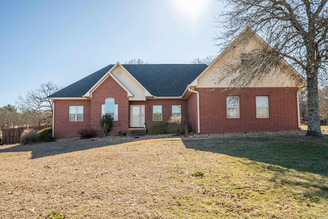 single story home featuring brick siding and a front yard