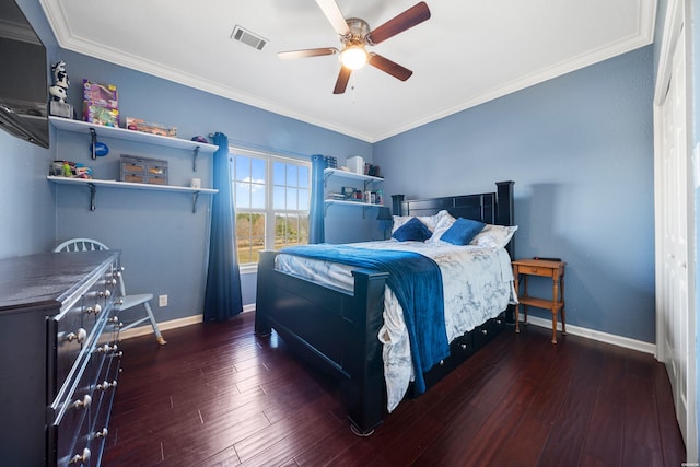 bedroom featuring baseboards, visible vents, wood finished floors, and ornamental molding