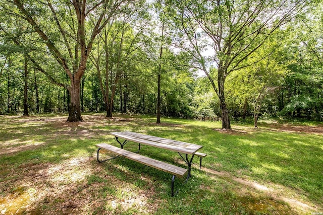 view of home's community with a yard and a forest view